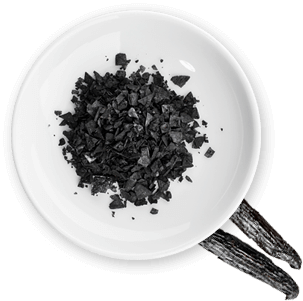 A plate of black sea salt grains 11248002